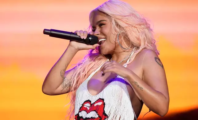 FILE - Karol G performs on day one of the Lollapalooza Music Festival in Chicago on Aug. 3, 2023. (Photo by Rob Grabowski/Invision/AP, File)