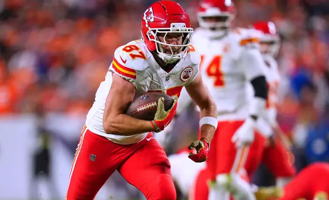 Kansas City Chiefs tight end Travis Kelce scores during the second half an NFL football game against the Denver Broncos Sunday, Nov. 16, 2025, in Denver. (AP Photo/Jack Dempsey)