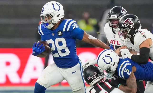 Indianapolis Colts running back Jonathan Taylor (28) runs with the ball during an NFL football game against the Atlanta Falcons, Sunday, Nov. 9, 2025, in Berlin, Germany. (AP Photo/Martin Meissner)