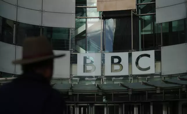 Pedestrian walks outside the BBC Headquarters in London, Wednesday, Nov. 12, 2025. (AP Photo/Kin Cheung)