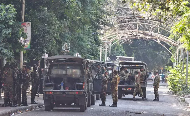 Bangladeshi army soldiers guard outside the demolished residence of Sheikh Mujibur Rahman, Bangladesh's former leader and the father of the country's ousted Prime Minister Sheikh Hasina a day after Hasina was sentenced to death, in Dhaka, Bangladesh, Tuesday, Nov. 18, 2025. (AP Photo/ Rajib Dhar)