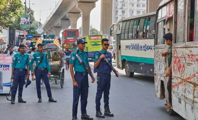 Policemen stand guard on a street a day after ousted Prime Minister Sheikh Hasina was sentenced to death, in Dhaka, Bangladesh, Tuesday, Nov. 18, 2025. (AP Photo/ Rajib Dhar)
