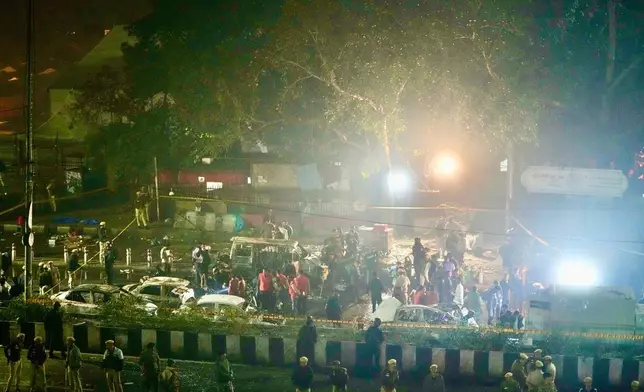 Security officials inspect the scene of a car explosion near the historic Red Fort in New Delhi, India, Monday, Nov. 10, 2025. (AP Photo/Manish Swarup)