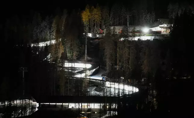 A night view of the Eugenio Monti sliding track during a three day skeleton and bobsled World Cup stage and Olympic test event in Cortina D'Ampezzo, Friday, Nov. 21, 2025. (AP Photo/Andrew Medichini)