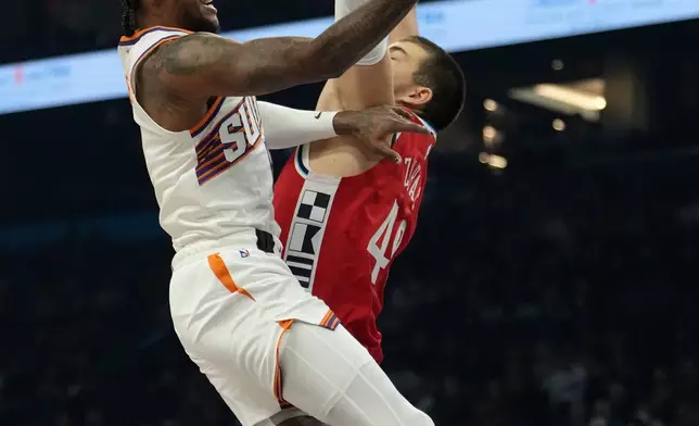 Phoenix Suns guard Jalen Green, left, drives past Los Angeles Clippers center Ivica Zubac (40) to score during the first half of an NBA basketball game Thursday, Nov. 6, 2025, in Phoenix. (AP Photo/Ross D. Franklin)