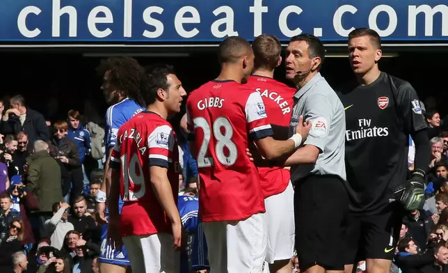 FILE - Arsenal's Kieran Gibbs, No 28, questions the referee Andre Marriner, in grey, after being shown a red card during their English Premier League soccer match between Chelsea and Arsenal at Stamford Bridge stadium in London on March 22 2014. (AP Photo/Alastair Grant, File)