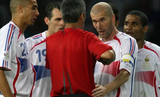 FILE- France's Zinedine Zidane, second from right, has words with Argentine Horacio Elizondo, center after receiving a red card during extra time in the final of the soccer World Cup between Italy and France in the Olympic Stadium in Berlin, on July 9, 2006. (AP Photo/Dusan Vranic)