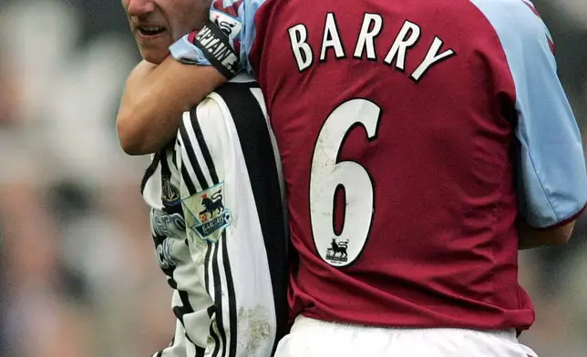 FILE - Aston Villa's Gareth Barry, right, holds back Newcastle Untied's Lee Bowyer from fighting with teammate Kieron Dyer during their English Premier League soccer match at Newcastle's St James' Park, England, on April 2, 2005. (AP Photo/Scott Heppell)