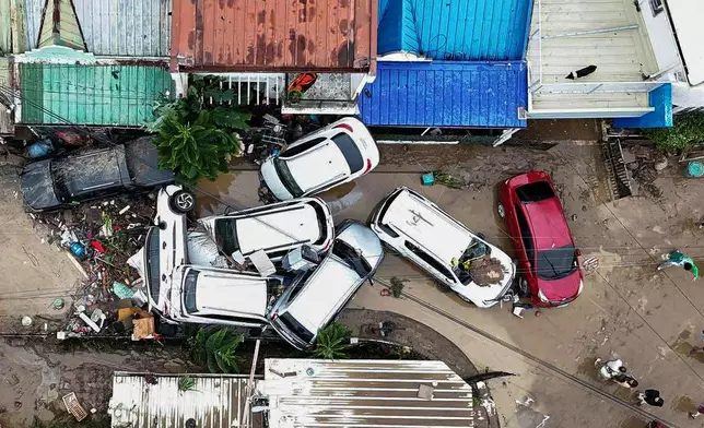 Cars are piled on top of each other after flooding caused by Typhoon Kalmaegi in Cebu city, central Philippines, Tuesday, Nov. 4, 2025. (AP Photo/Jacqueline Hernandez)
