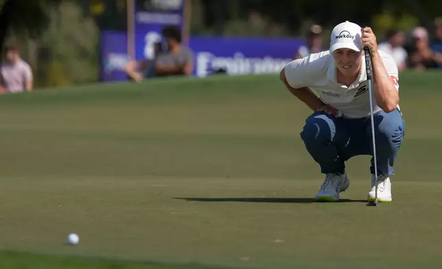 Matt Fitzpatrick of England lines up a putt on the 5th green during the final round of World Tour Golf Championship in Dubai, United Arab Emirates, Sunday, Nov. 16, 2025. (AP Photo/Altaf Qadri)