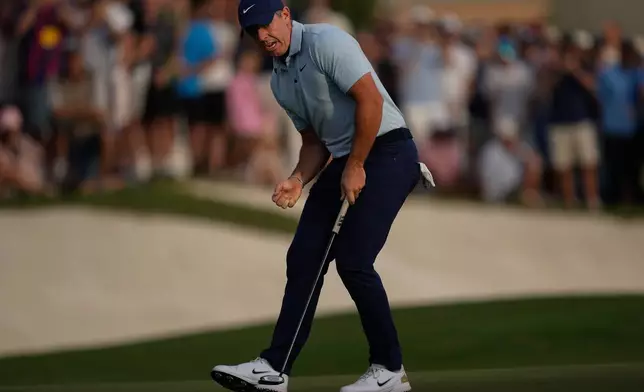 Rory McIlroy of Northern Ireland reacts after putting on the 18th hole to earn play-off with Matt Fitzpatrick of England during the final round of World Tour Golf Championship in Dubai, United Arab Emirates, Sunday, Nov. 16, 2025. (AP Photo/Altaf Qadri)