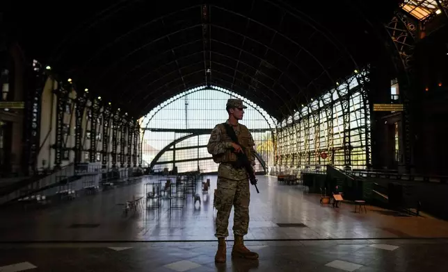 A soldier guards the old Mapocho train station, now a cultural center, that will be used as a polling station for the general election in Santiago, Chile, Friday, Nov. 14, 2025. (AP Photo/Esteban Felix)