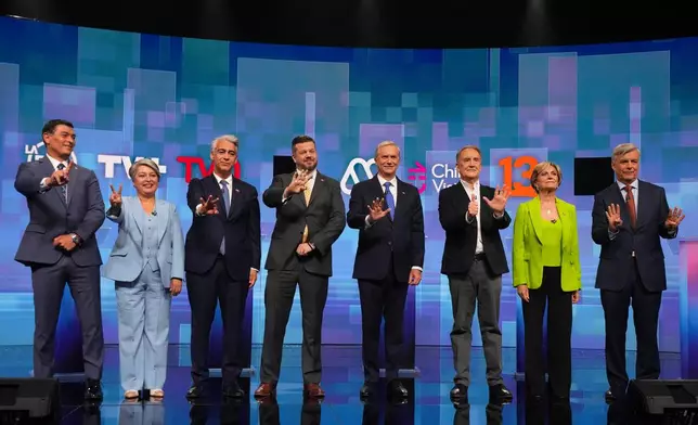 From left, presidential candidates Franco Parisi of the Party of the People, Jeannette Jara of the Unidad por Chile coalition, Marco Enriquez-Ominami of the Progressive Party, Johannes Kaiser of the National Libertarian Party, Jose Antonio Kast of the Republican Party, Eduardo Artes of the Proletarian Action Party, Evelyn Matthei of the Chile Vamos coalition and Independent Harold Mayne-Nicholls gesture prior to a debate ahead of the November general elections, in Santiago, Chile, Monday, Nov. 10, 2025. (AP Photo/Esteban Felix)