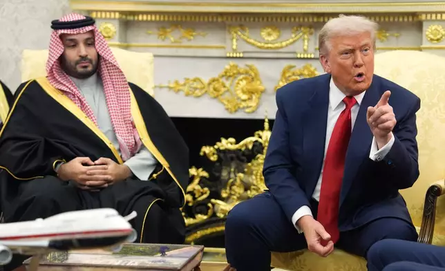 President Donald Trump points to a reporter as he meets Saudi Arabia's Crown Prince Mohammed bin Salman in the Oval Office of the White House, Tuesday, Nov. 18, 2025, in Washington. (AP Photo/Evan Vucci)