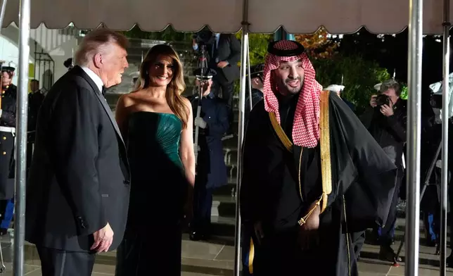 President Donald Trump and first lady Melania Trump welcome Saudi Arabia's Crown Prince Mohammed bin Salman for a dinner at the White House, Tuesday, Nov. 18, 2025, in Washington. (AP Photo/Alex Brandon)