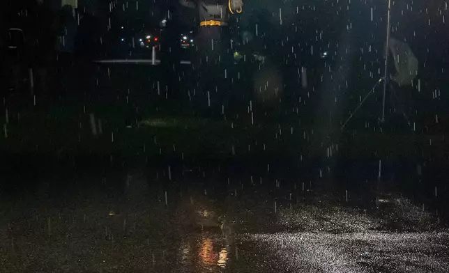 The conductor directs the the herald trumpets in the rain as President Donald Trump and first lady Melania Trump greet Saudi Arabia's Crown Prince Mohammed bin Salman for a dinner at the White House, Tuesday, Nov. 18, 2025, in Washington. (AP Photo/Alex Brandon)