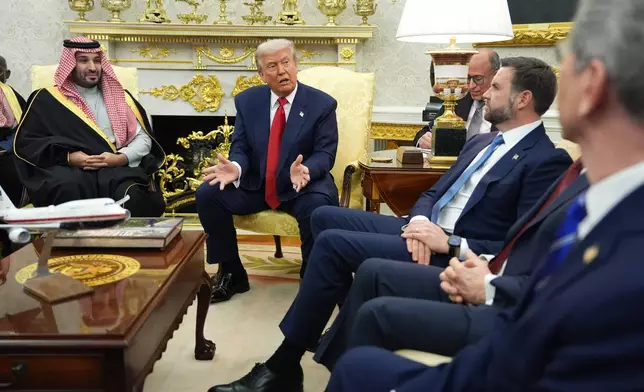 President Donald Trump meets Saudi Arabia's Crown Prince Mohammed bin Salman in the Oval Office of the White House, Tuesday, Nov. 18, 2025, in Washington, As Vice President JD Vance and Treasury Secretary Scott Bessent listen. (AP Photo/Evan Vucci)