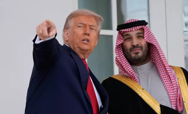 President Donald Trump walks with Saudi Arabia's Crown Prince Mohammed bin Salman along the colonnade, at the White House, Tuesday, Nov. 18, 2025, in Washington. (AP Photo/Alex Brandon)
