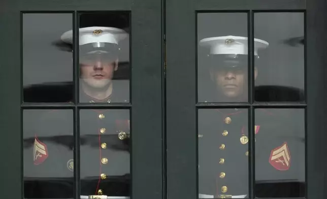 U.S. Marine Corps prepare to open the doors to the Diplomatic Reception Room for visiting Saudi Arabia's Crown Prince Mohammed bin Salman at the White House, Tuesday, Nov. 18, 2025, in Washington. (AP Photo/Mark Schiefelbein)