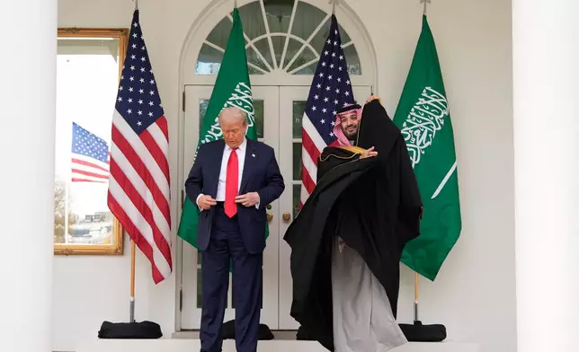 President Donald Trump walks with Saudi Arabia's Crown Prince Mohammed bin Salman along the colonnade toward the Oval Office, at the White House, Tuesday, Nov. 18, 2025, in Washington. (AP Photo/Alex Brandon)