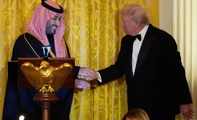 President Donald Trump and Saudi Arabia's Crown Prince Mohammed bin Salman shake hands during a dinner in the East Room of the White House, Tuesday, Nov. 18, 2025, in Washington. (AP Photo/Alex Brandon)