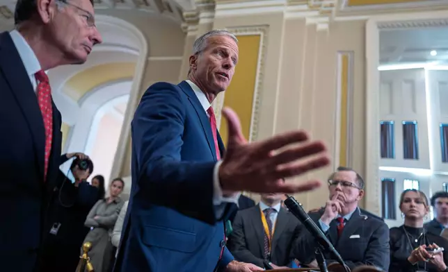 Senate Majority Leader John Thune, R-S.D., joined at left by Sen. John Barrasso, R-Wyo., the GOP whip, talks with reporters following a closed-door strategy session, on day 35 of the government shutdown, at the Capitol in Washington, Tuesday, Nov. 4, 2025. (AP Photo/J. Scott Applewhite)