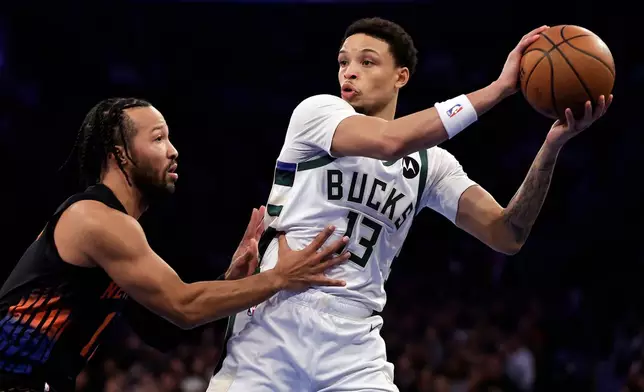 Milwaukee Bucks guard Ryan Rollins (13) looks to pass around New York Knicks guard Jalen Brunson during the first half of an NBA basketball game, Friday, Nov. 28, 2025, in New York. (AP Photo/Adam Hunger)