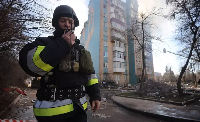 A rescuer works in front of a residential building which was heavily damaged by a Russian strike on Ternopil, Ukraine, on Wednesday, Nov. 19, 2025. (AP Photo/Rostyslav Kovalchuk)