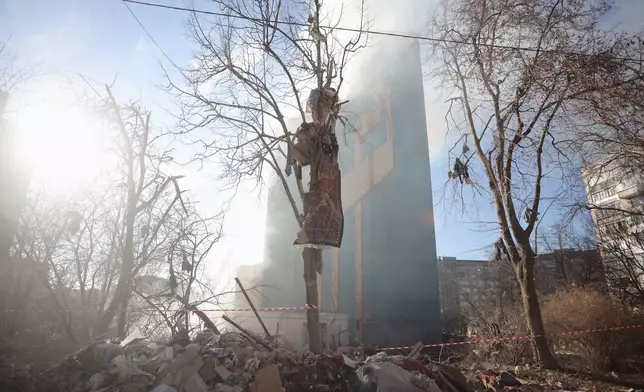Smoke rises from a residential building which was heavily damaged by a Russian strike on Ternopil, Ukraine, on Wednesday, Nov. 19, 2025. (AP Photo/Rostyslav Kovalchuk)