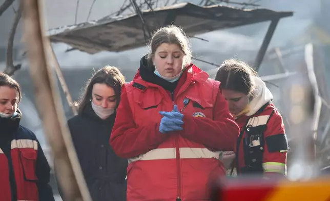 A paramedic cries standing in front of of a residential building which was heavily damaged by a Russian strike, in Ternopil, Ukraine, Wednesday, Nov. 19, 2025. (AP Photo/Vlad Kravchuk)