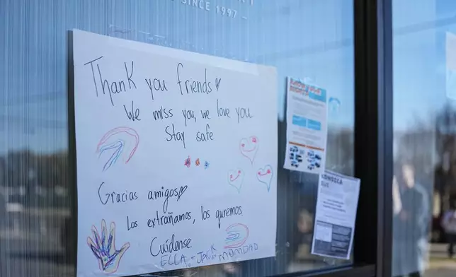 A sign of support is posted outside of Manolo's bakery which is closed amidst federal law enforcement presence, Monday, Nov. 17, 2025, in Charlotte, N.C. (AP Photo/Matt Kelley)