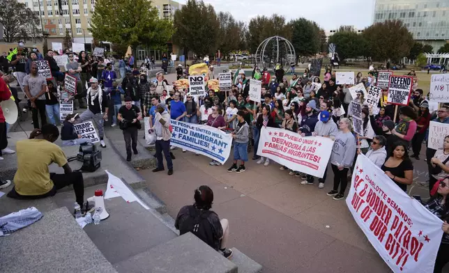 People protest against federal immigration enforcement Saturday, Nov. 15, 2025, in Charlotte, N.C. (AP Photo/Erik Verduzco)