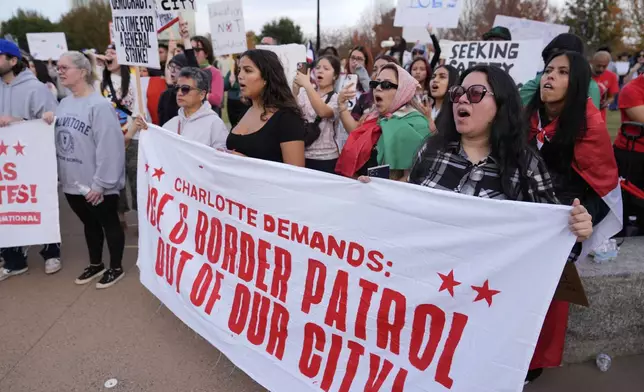 People protest against federal immigration enforcement Saturday, Nov. 15, 2025, in Charlotte, N.C. (AP Photo/Erik Verduzco)