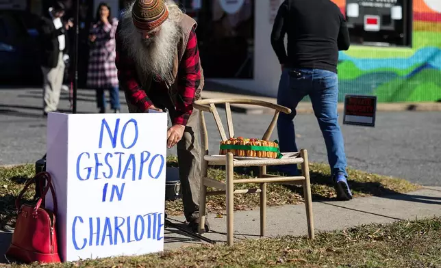 Protestors set up outside of Manolo's Bakery amidst federal law enforcement, Monday, Nov. 17, 2025, in Charlotte, N.C. (AP Photo/Matt Kelley)