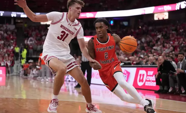 Campbell's Jeremiah Williamson-Johnson tries to get past Wisconsin's Nolan Winter during the first half of an NCAA college basketball game Monday, Nov. 3, 2025, in Madison, Wis. (AP Photo/Morry Gash)