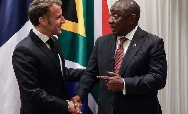 France's President Emmanuel Macron, left, shakes hands with South Africa's President Cyril Ramaphosa during their bilateral meeting at the Sandton Convention Centre in Sandton, South Africa, Friday Nov. 21, 2025, ahead of the G20 leaders' Summit. (Ludovic Marin/Pool Photo via AP)