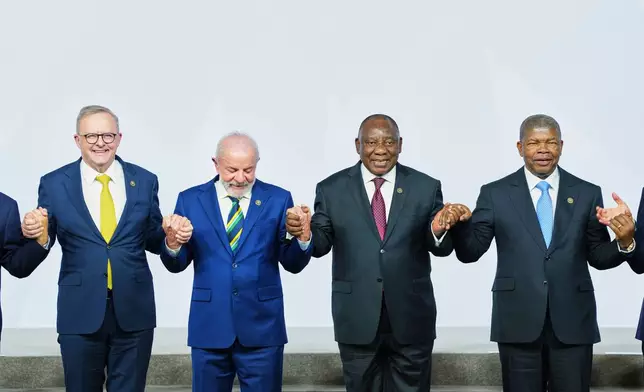 Australia's Prime Minister Anthony Albanese, Brazil's President Luiz Inacio Lula da Silva, South Africa's President Cyril Ramaphosa and. President of Angola and Chairperson of the African Union Joao Lourenco gesture as leaders gather for a group photo at the G20 leaders' summit in Johannesburg, South Africa, Saturday, Nov. 22, 2025. (AP Photo/Misper Apawu, Pool)