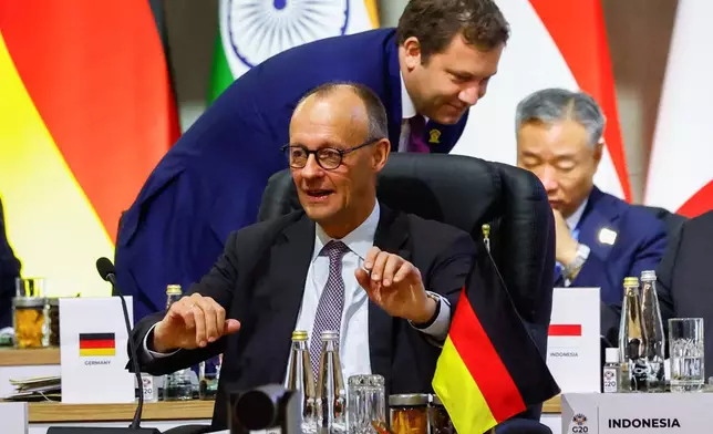 German Chancellor Friedrich Merzi attends a plenary session on the opening day of the G20 Summit at the Nasrec Expo Centre, in Johannesburg, South Africa, Saturday, Nov. 22, 2025. (Thomas Mukoya/Pool Photo via AP)