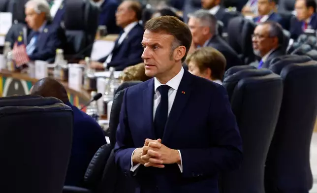 France's President Emmanuel Macron attends a plenary session on the opening day of the G20 Summit at the Nasrec Expo Centre, in Johannesburg, South Africa, Saturday, Nov. 22, 2025. (Thomas Mukoya/Pool Photo via AP)