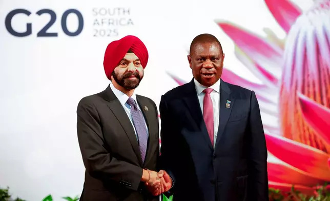 South African Deputy President Paul Mashatile, right, welcomes World Bank President Ajay Banga on the opening day of the G20 Summit at the Nasrec Expo Centre in Johannesburg, South Africa, Saturday, Nov. 22, 2025. (Thomas Mukoya/Pool Photo via AP)