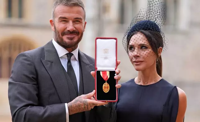 Sir David Beckham, with his wife Lady Victoria, after he was made a Knight Bachelor at an investiture ceremony at Windsor Castle, Berkshire, England, Tuesday, Nov. 4, 2025. (Andrew Matthews/Pool Photo via AP)