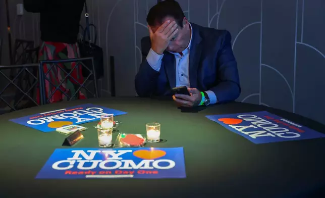 A supporter for independent mayoral candidate Andrew Cuomo watches election night returns during a watch party for Cuomo, Tuesday, Nov. 4, 2025, in New York. (AP Photo/Heather Khalifa)