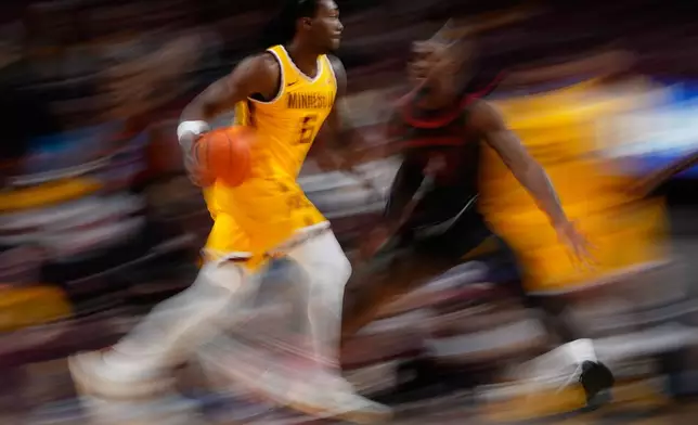 Minnesota guard Langston Reynolds (6) works toward the basket as Gardner-Webb guard DJ Jefferson (4), right, defends during the second half of an NCAA college basketball game Monday, Nov. 3, 2025, in Minneapolis. (AP Photo/Abbie Parr)