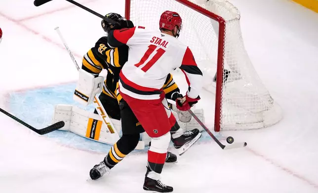 Carolina Hurricanes center Jordan Staal (11) scores on Boston Bruins goaltender Jeremy Swayman during the second period of an NHL hockey game, Monday, Nov. 17, 2025, in Boston. (AP Photo/Charles Krupa)