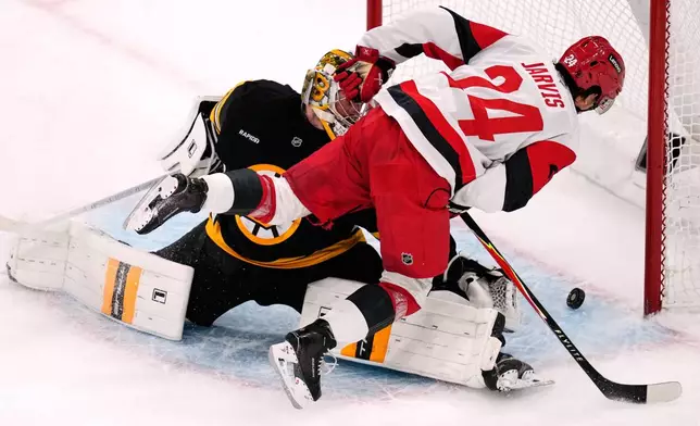 Carolina Hurricanes center Seth Jarvis (24) watches as his shot hits the post while trying to score on Boston Bruins goaltender Jeremy Swayman during the second period of an NHL hockey game, Monday, Nov. 17, 2025, in Boston. (AP Photo/Charles Krupa)