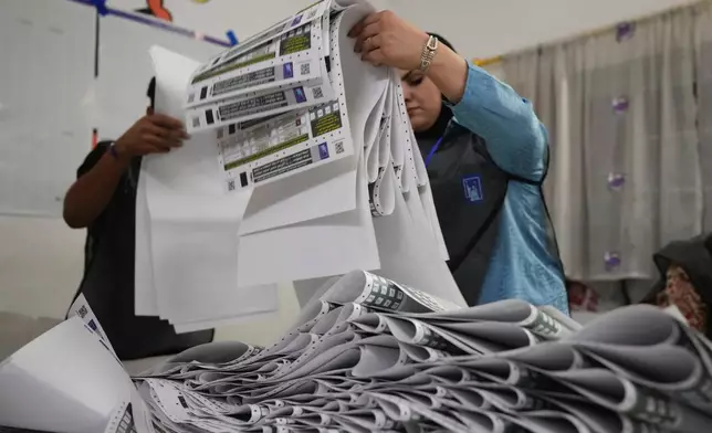 Election workers count ballots as they close a polling station, during the parliamentary elections in Baghdad, Iraq, Tuesday, Nov. 11, 2025. (AP Photo/Hadi Mizban)