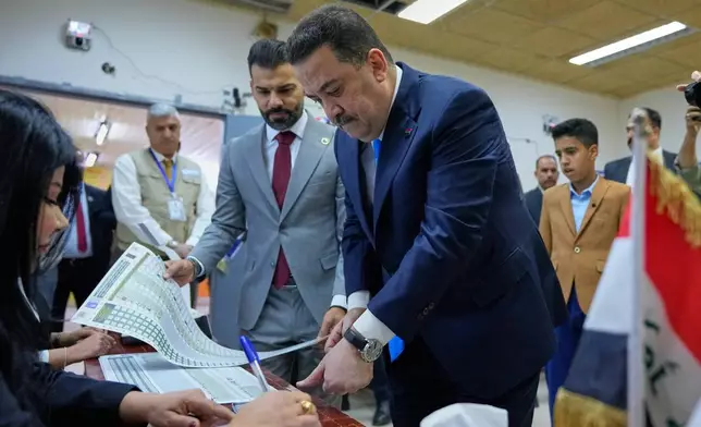 Iraqi Prime Minister Mohammed Shia al-Sudani his vote in the country's parliamentary election in Baghdad, Iraq, Tuesday, Nov. 11, 2025. (AP Photo/Hadi Mizban)