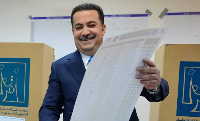 Iraqi Prime Minister Mohammed Shia al-Sudani casts his vote in the country's parliamentary election in Baghdad, Iraq, Tuesday, Nov. 11, 2025. (AP Photo/Hadi Mizban)