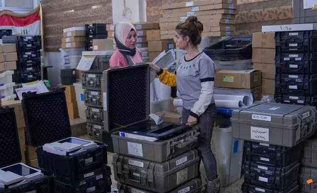 Workers from Iraq's electoral commission prepare voting materials, for the country's upcoming parliamentary elections on Nov. 11., at a polling station in Baghdad, Iraq, Thursday, Nov. 6, 2025. (AP Photo/Hadi Mizban)