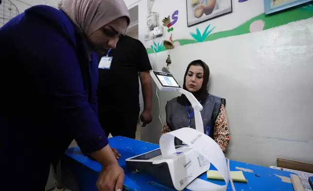 Election workers count ballots as they close a polling station, during the parliamentary elections in Baghdad, Iraq, Tuesday, Nov. 11, 2025. (AP Photo/Hadi Mizban)